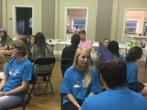 A group of people sitting in chairs and engaging in discussion for an event