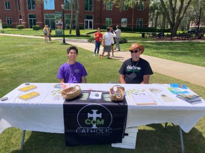 two students from the catholic campus ministry smiling during event