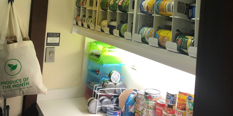canned goods on shelfs in a pantry