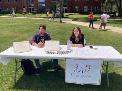 two students from religion and dialogue at event