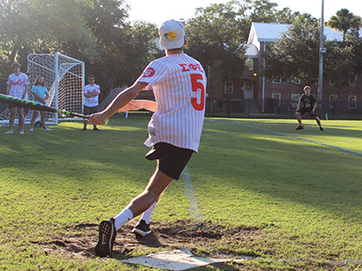 student batting on softball game