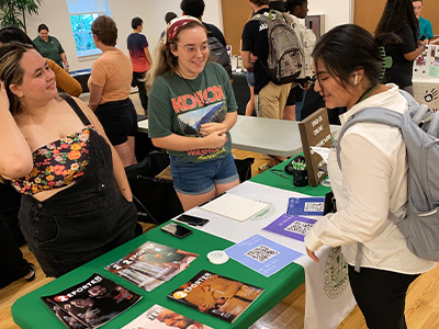  students showing their magazines on table