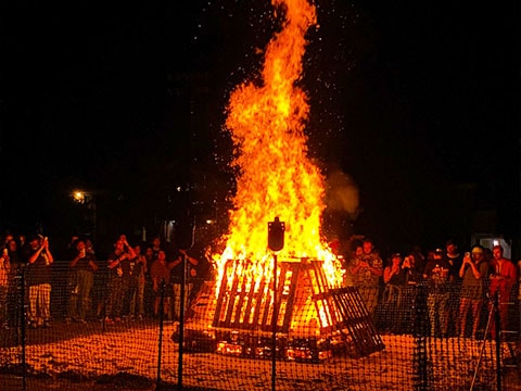 students around big bonfire during the night