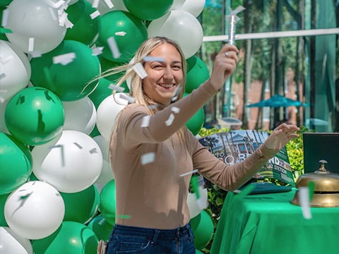 student celebrating with confetti during values day