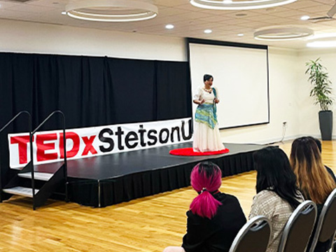 speaker giving a TEDx presenattion on campus