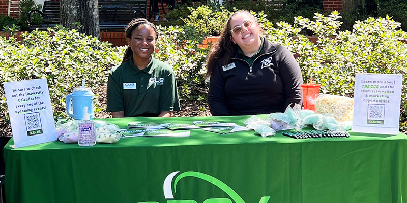 two students on vibrancy table smiling