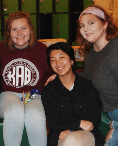 three students smiling together