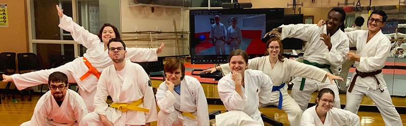 Aikido student group posing together in the studio