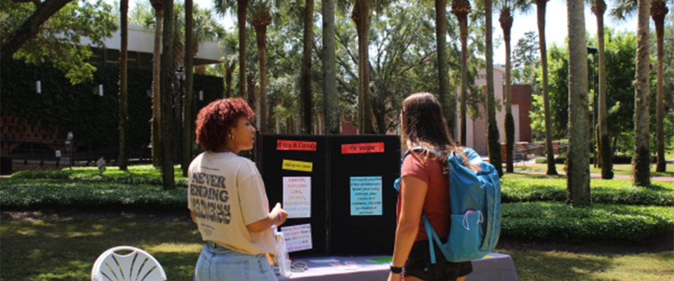 fronk scholar giving presentation outside