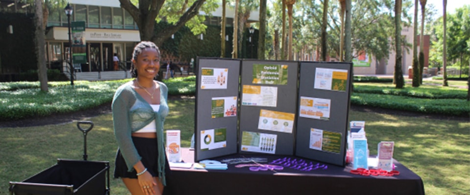 fronk scholar giving presentation outside