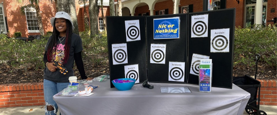 fronk scholar giving presentation outside