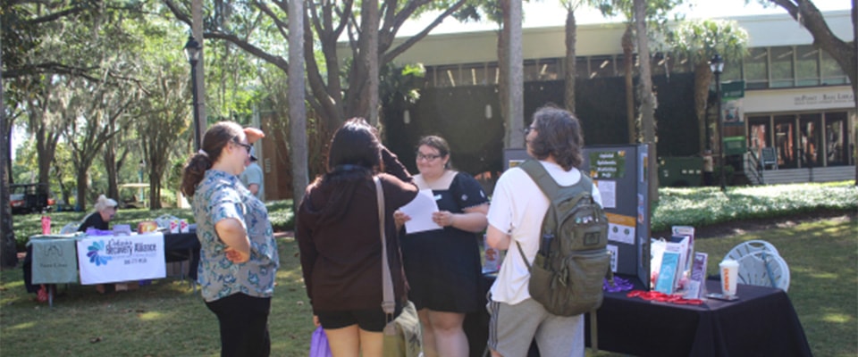 fronk scholar giving presentation outside