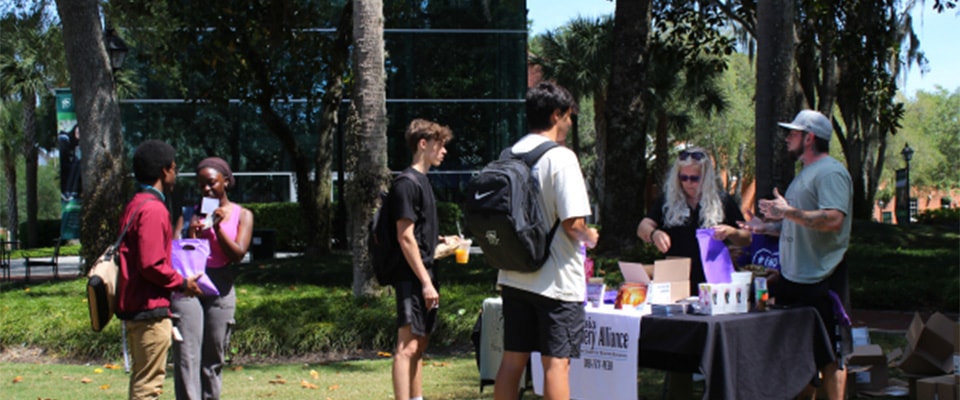 fronk scholar giving presentation outside