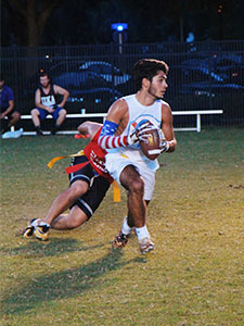 student running with ball playing flag football