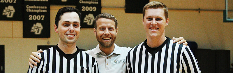 two students referees next to Travis Potter