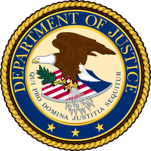 Eagle on American flag shield inside blue and gold emblem that says department of justice around it.