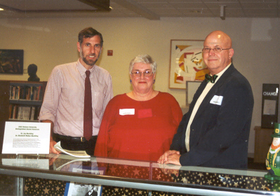 Paul Croce stands with Stetson University Distinguished Alumni Elizabeth Walker Mechling and Jay Mechling at the library display of their works, set up by librarian Debbie Dinkins