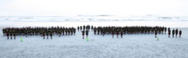 rotc students posing for gorup picture on beach
