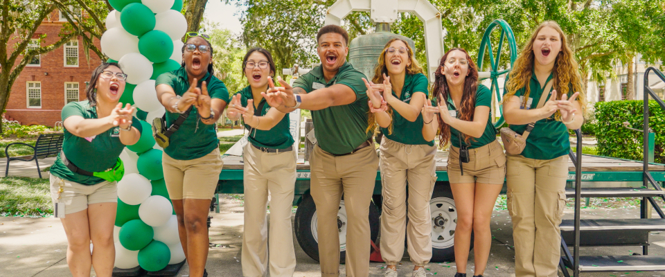 seven students smiling and making an 