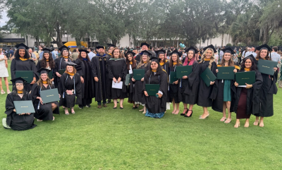 large group of students and faculty in graduation regalia