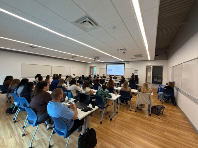 a room full of students attending a presentation