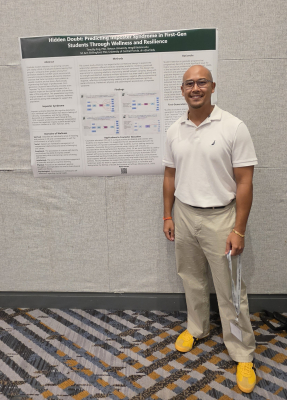 Timothy Eng standing at his conference poster