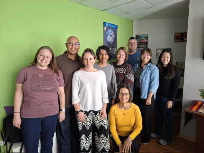 nine people smiling at camera