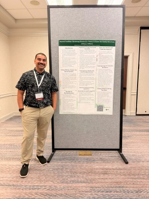 Student Anthony Williams poses with a poster