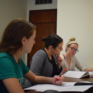 three women working on research