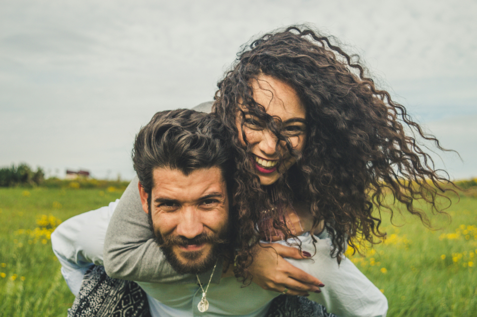 a man and woman smiling at the camera