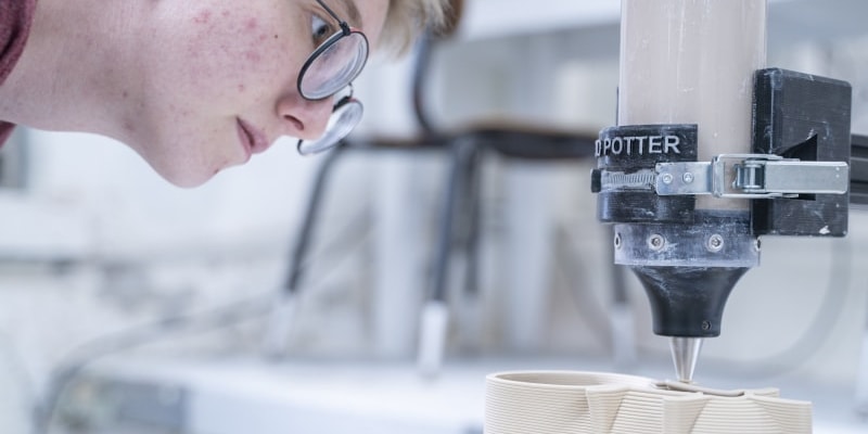 student using 3d printing for ceramics