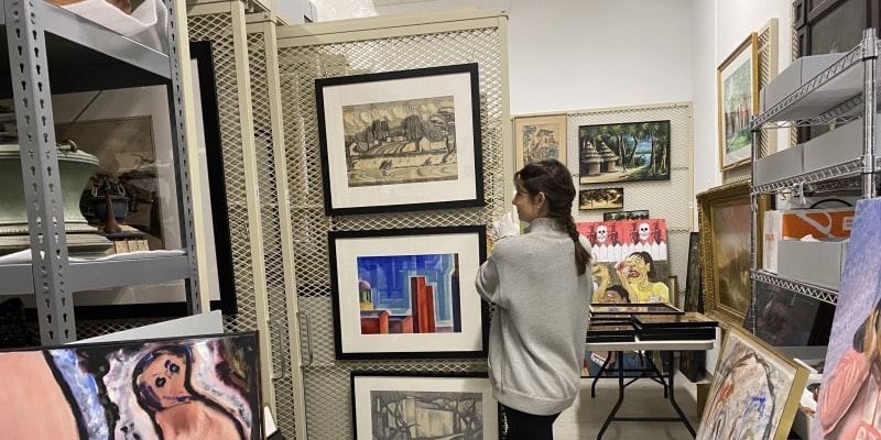 student reviwing art pieces for museum studies