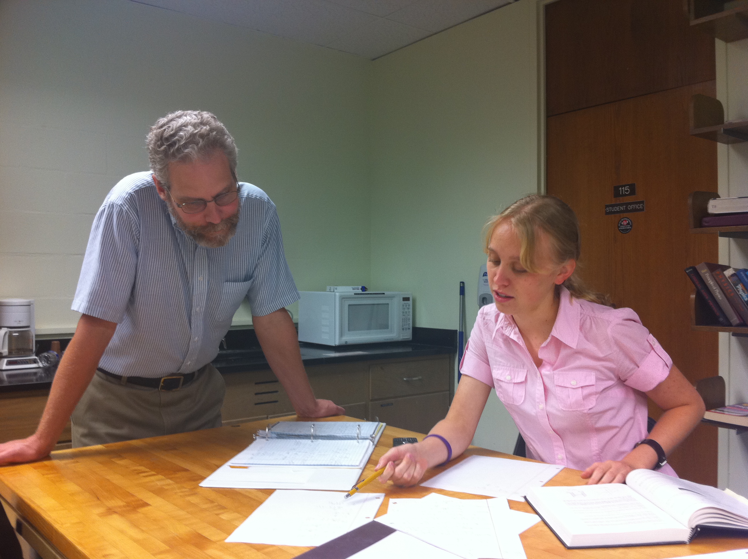 Dr. Glander assisting a physics major working on a research project