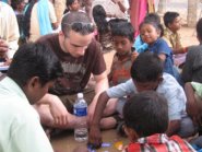 Student playing with kids