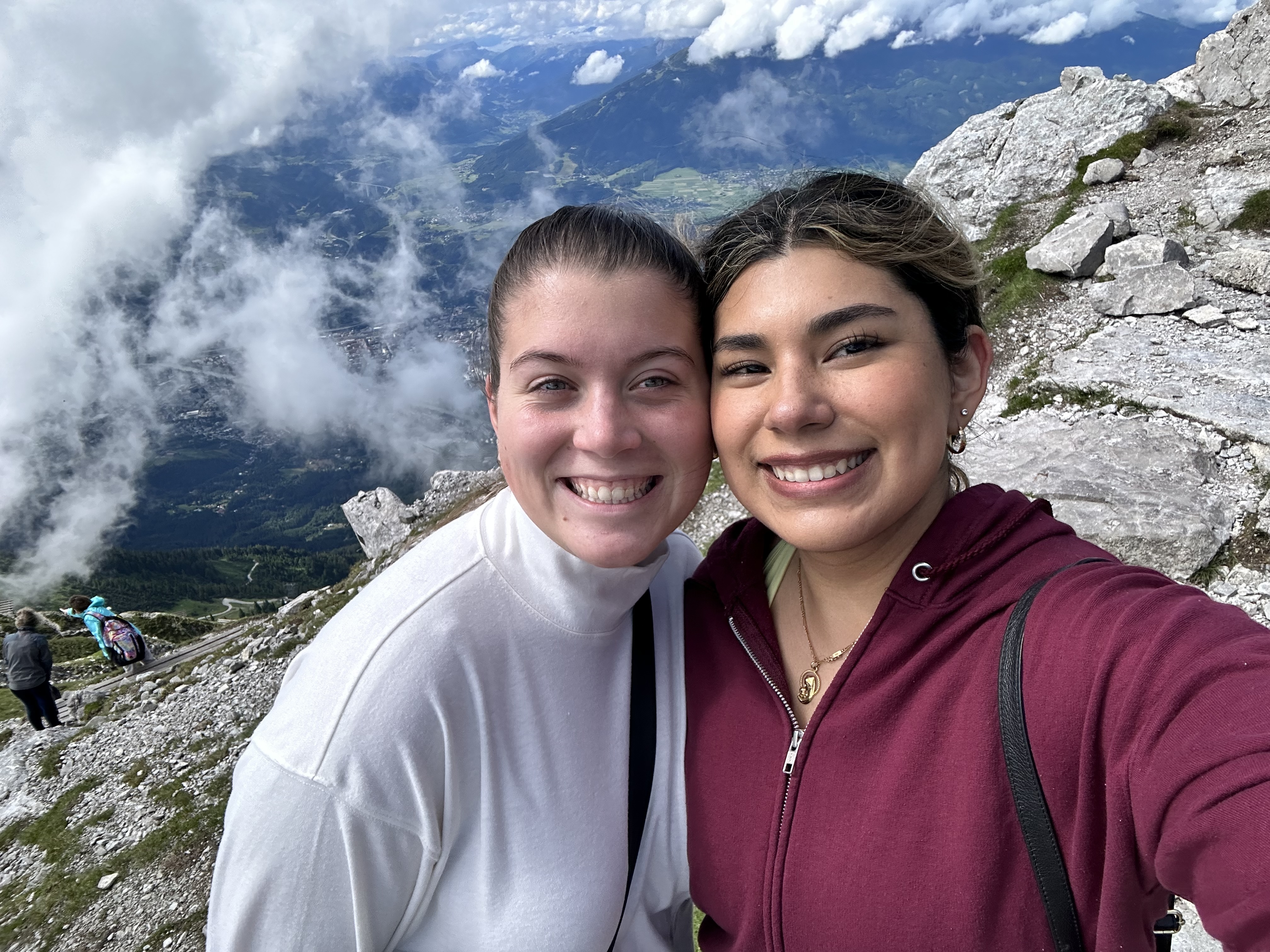 two girls taking a picture in teh mountains 