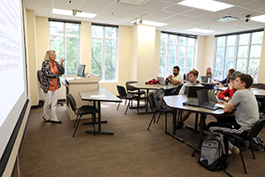 Lou Paris conversing with student