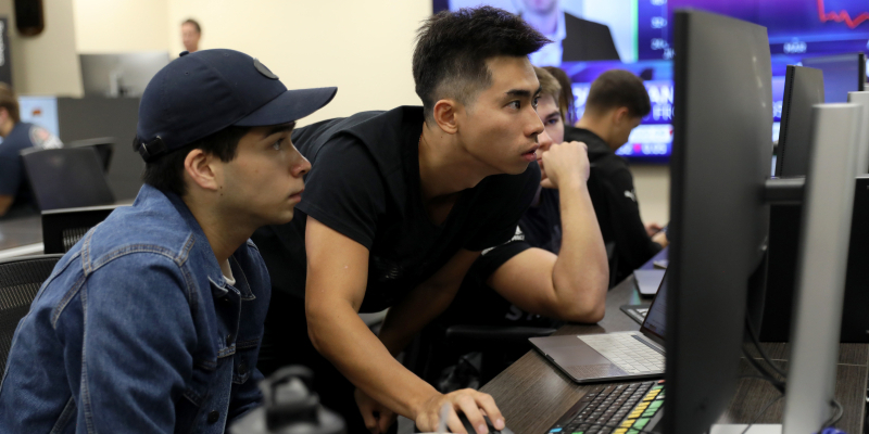 students in lab looking working on a computer attentively