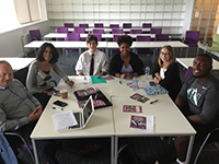 professor and students work together in small group