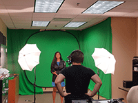 sport business student does interview in front of green screen