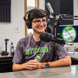 student talking in a radio booth