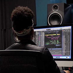 student working on a computer in the sound lab