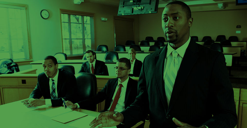 Students practicing law in a courtroom.