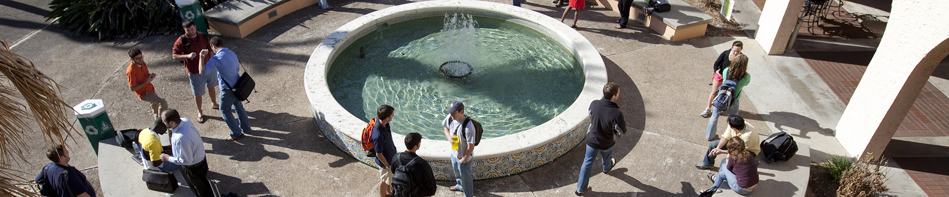 students hanging around the fountain in the courtyard