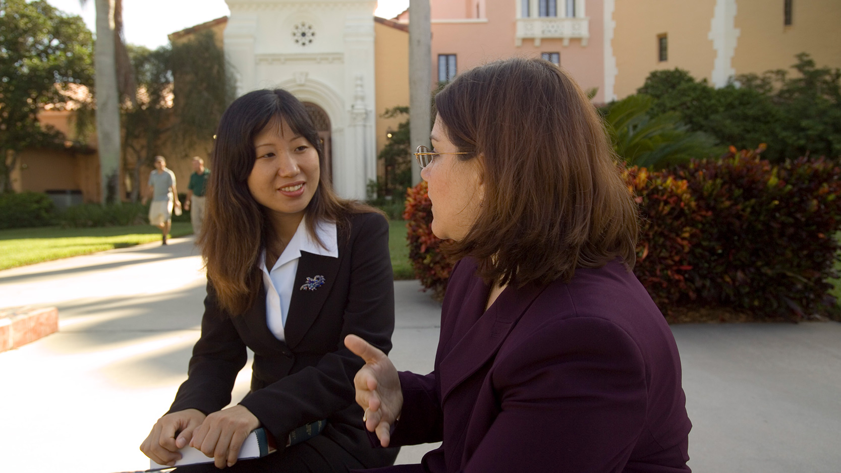 Two students talking in the plaza mayor courtyard