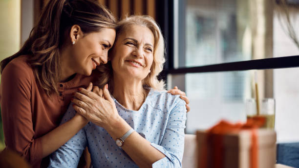 a younger woman and older woman embracing