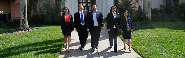 Five people walking on sidewalk at Stetson University College of Law