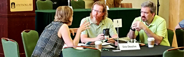 conference participants talk with each other at table