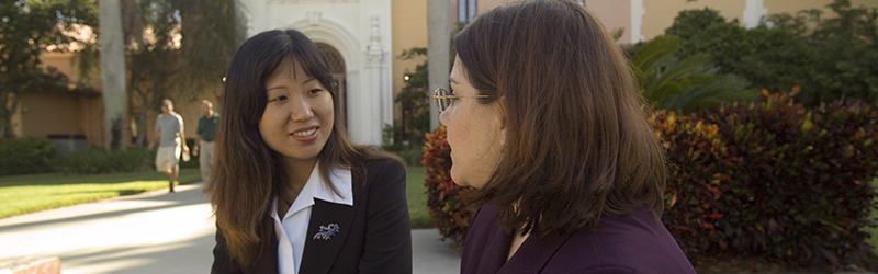student and professor talking in plaza mayor