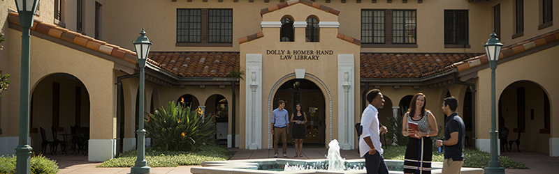 students talking outside of the dolly homer hand library