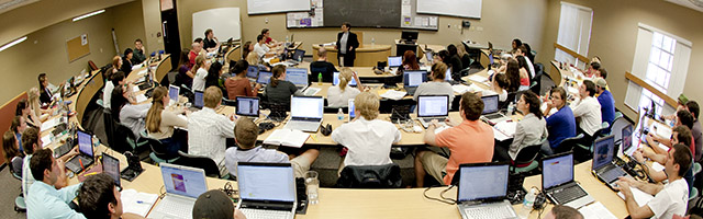 large classroom with students looking at professor